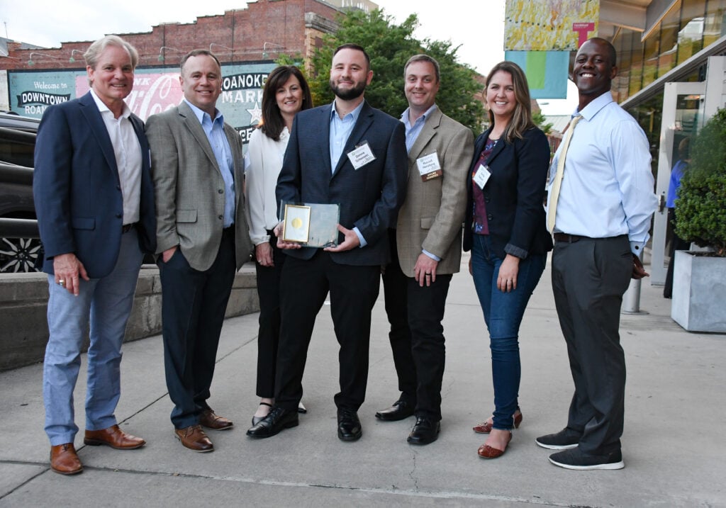 Group of people holding an award