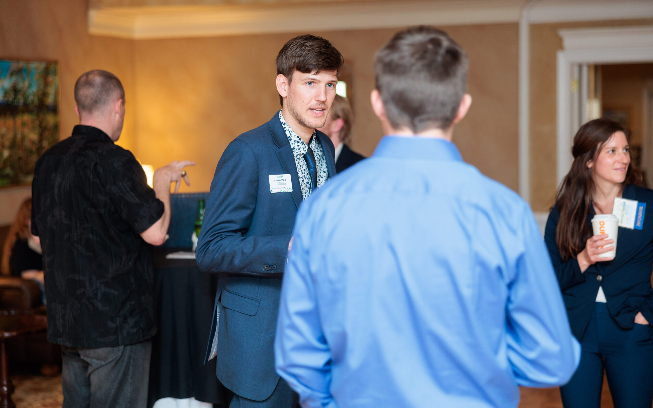 2 men talking to each other at an event