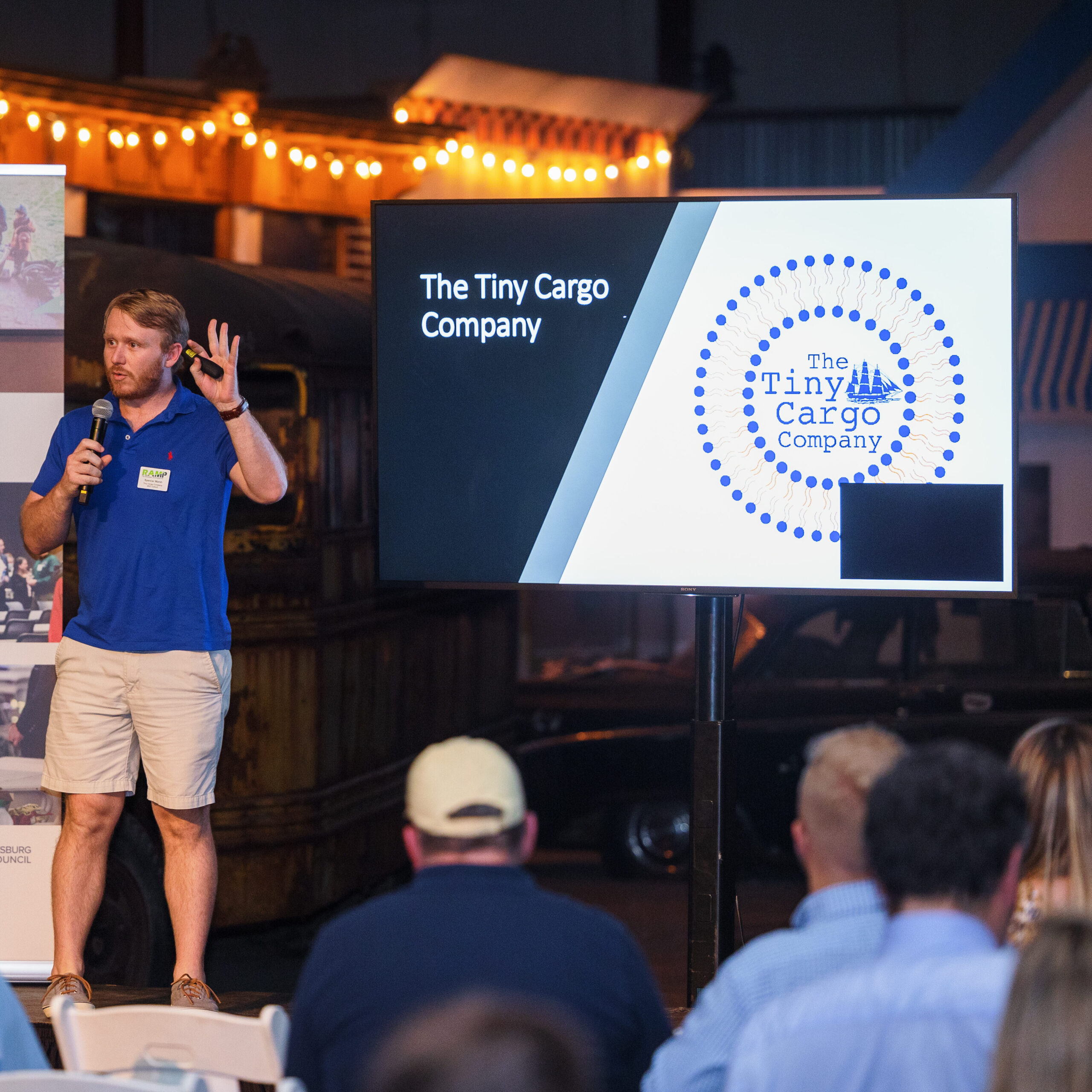 A man on a stage giving a presentation