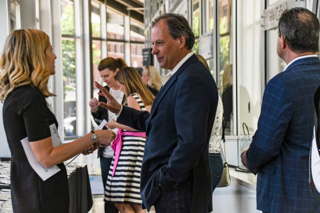 A man and woman talking at an event